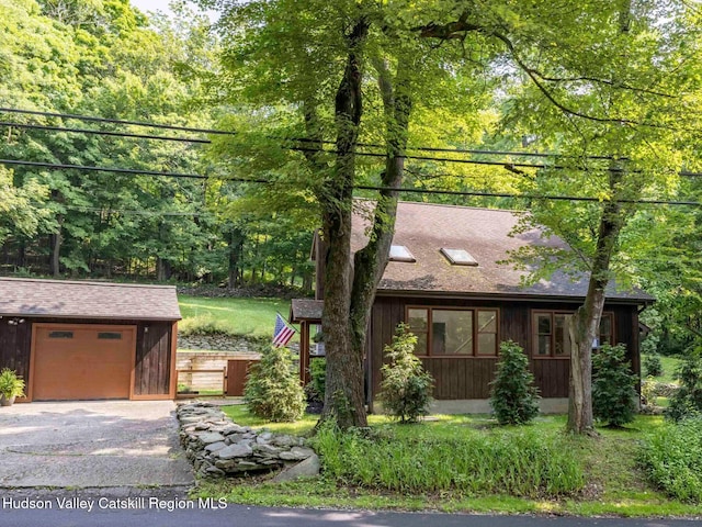221 Cardinal Rd, Hyde Park, NY 12538 - view of front of house featuring asphalt driveway, a garage, an outbuilding, and roof with shingles