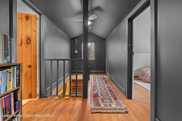 corridor featuring hardwood / wood-style floors and lofted ceiling