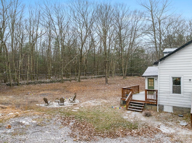 view of yard with a fire pit and a deck