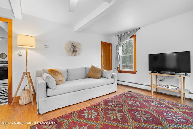 living room with baseboard heating, beamed ceiling, and wood-type flooring