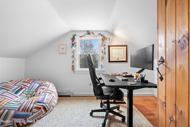 bedroom with lofted ceiling and baseboard heating