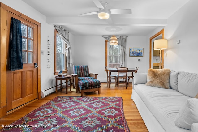 living room featuring a baseboard radiator, light hardwood / wood-style flooring, and ceiling fan