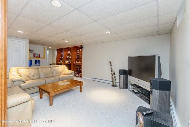 carpeted living area featuring a baseboard heating unit, recessed lighting, baseboards, and a paneled ceiling