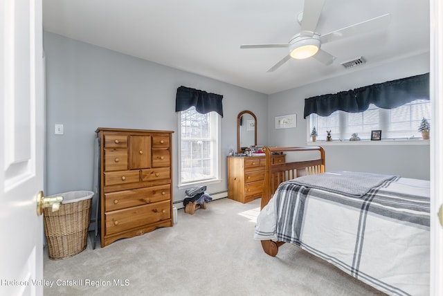 carpeted bedroom featuring visible vents and a ceiling fan