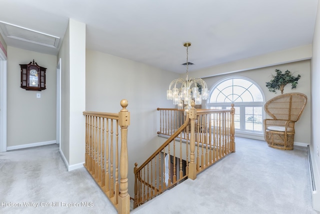 corridor with an upstairs landing, carpet flooring, and baseboards