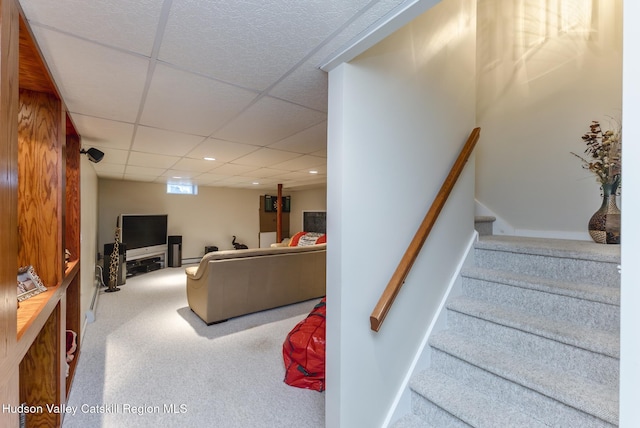 stairs with a drop ceiling, recessed lighting, and carpet floors