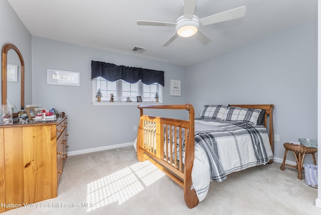 carpeted bedroom featuring visible vents, a ceiling fan, and baseboards