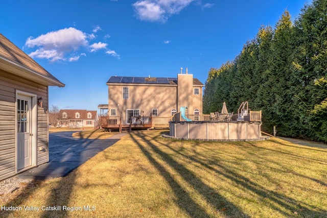 view of yard with an outdoor pool and a deck