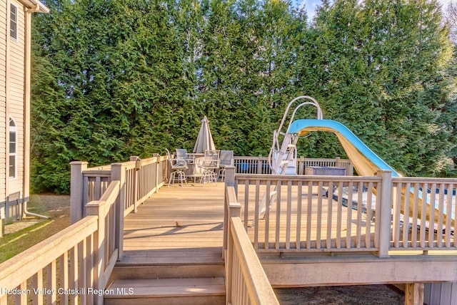 wooden deck featuring outdoor dining space