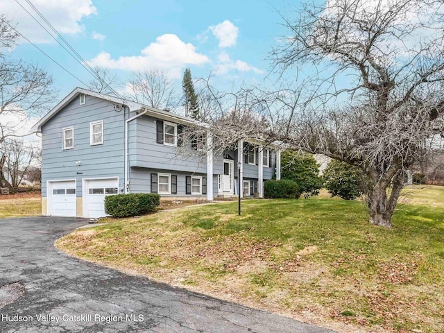 view of front of property with a front yard and a garage