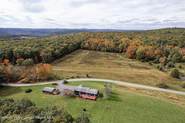 birds eye view of property featuring a view of trees and a rural view