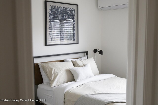bedroom with a wall mounted AC