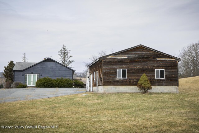 view of property exterior featuring a lawn
