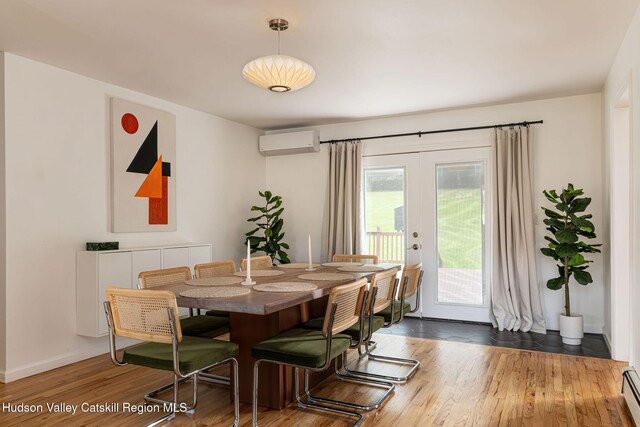 dining area with a wall mounted air conditioner, french doors, baseboards, wood finished floors, and a baseboard heating unit