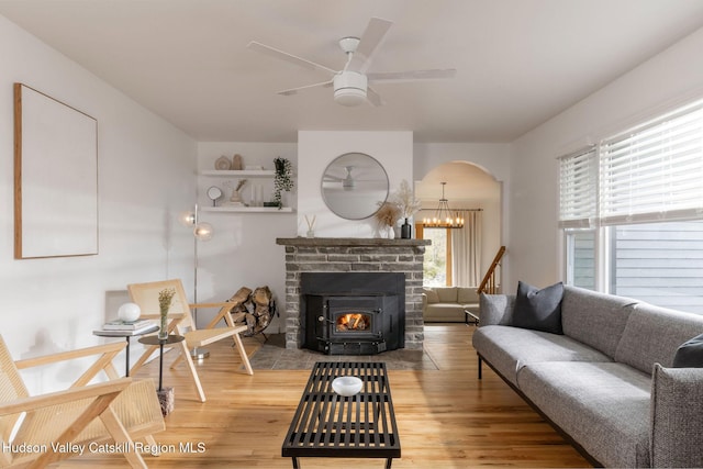 living room with arched walkways, ceiling fan, and wood finished floors