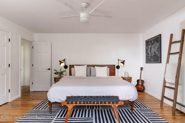 bedroom with baseboards, ceiling fan, and light wood-type flooring