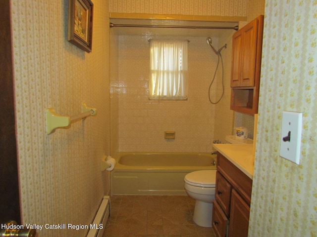 full bathroom featuring vanity, toilet, baseboard heating, and tiled shower / bath combo