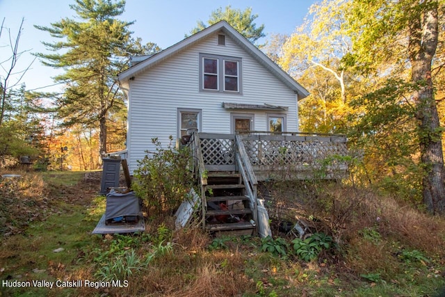 back of house with a wooden deck