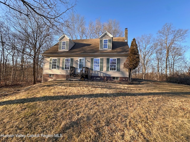 cape cod home with a chimney and a front lawn