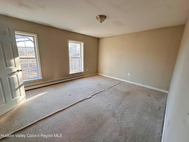 carpeted spare room featuring baseboards and baseboard heating