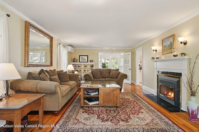 242 N Manor Ave, Kingston, NY 12401 - living area featuring light wood-style floors, a wall unit AC, crown molding, a tile fireplace, and baseboards