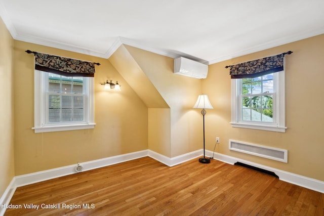 242 N Manor Ave, Kingston, NY 12401 - additional living space with a wall mounted air conditioner, baseboards, and wood finished floors