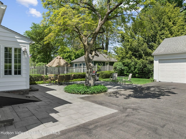 242 N Manor Ave, Kingston, NY 12401 - view of patio / terrace with outdoor dining area, a garage, and asphalt driveway