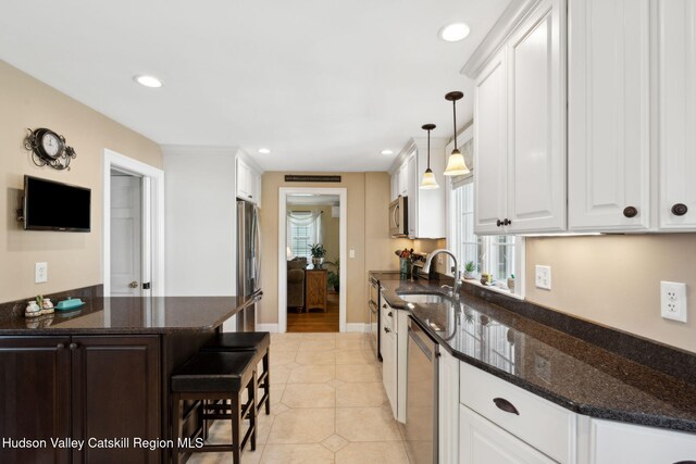 242 N Manor Ave, Kingston, NY 12401 - kitchen featuring appliances with stainless steel finishes, a sink, white cabinets, light tile patterned floors, and recessed lighting