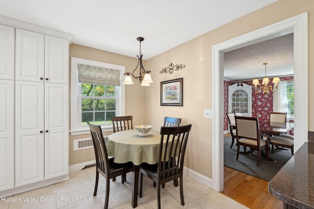 242 N Manor Ave, Kingston, NY 12401 - dining room featuring a chandelier, baseboards, and light wood-type flooring
