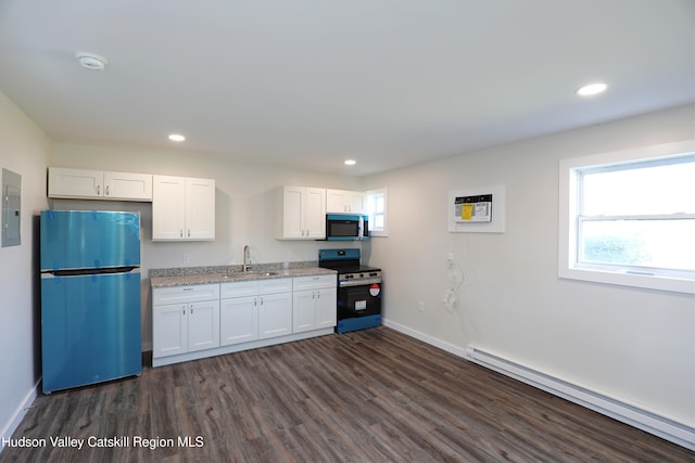 kitchen with white cabinets, sink, appliances with stainless steel finishes, and a baseboard radiator