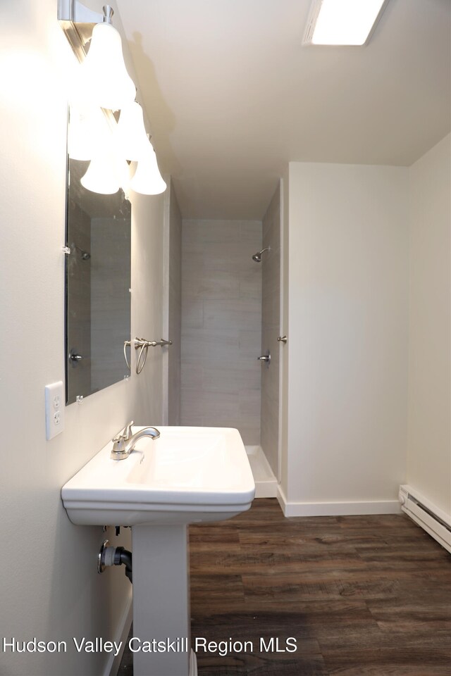 14311 Rte 9w, New Baltimore, NY 12124 - full bathroom with a tile shower, baseboard heating, wood finished floors, and baseboards