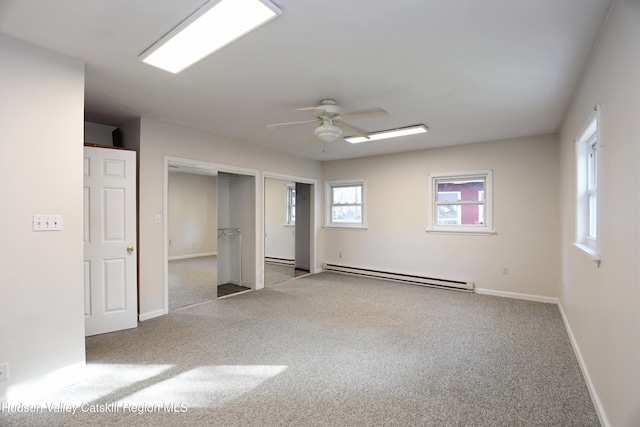 14311 Rte 9w, New Baltimore, NY 12124 - unfurnished bedroom featuring baseboard heating, baseboards, a baseboard heating unit, carpet flooring, and multiple closets