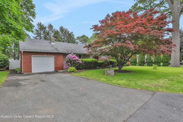 12 Roming Ln, Saugerties, NY 12477 - view of front of house featuring a garage, brick siding, a chimney, a front lawn, and asphalt driveway