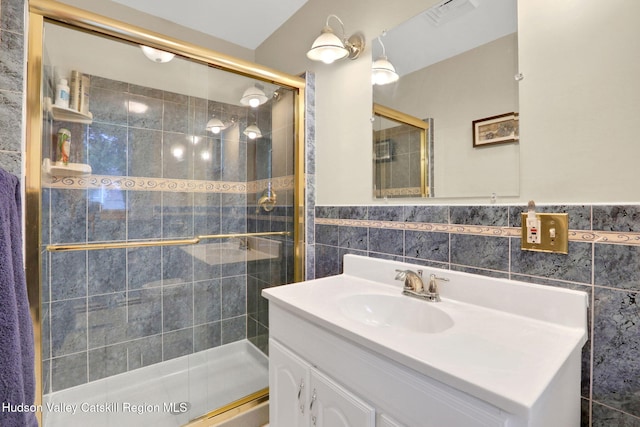 12 Roming Ln, Saugerties, NY 12477 - full bathroom featuring vanity, a stall shower, tile walls, and a wainscoted wall