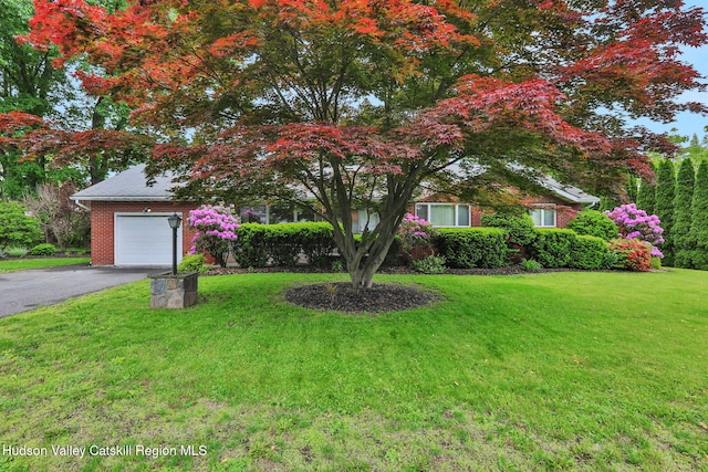 12 Roming Ln, Saugerties, NY 12477 - view of property hidden behind natural elements featuring driveway, an attached garage, a front yard, and brick siding