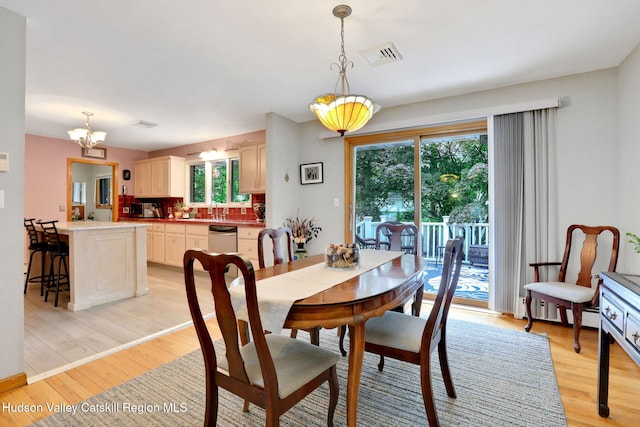 12 Roming Ln, Saugerties, NY 12477 - dining space featuring a chandelier, light wood-style flooring, healthy amount of natural light, and a baseboard heating unit