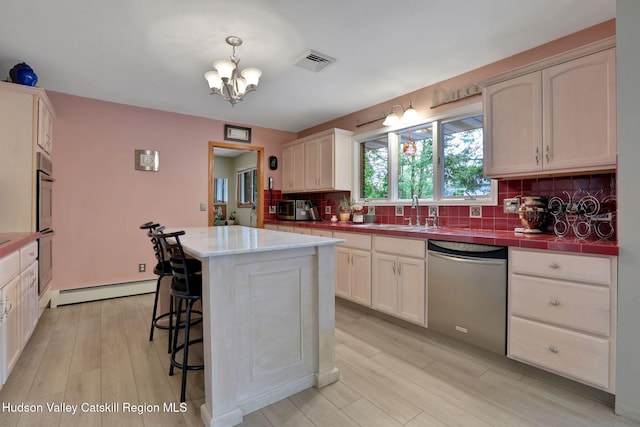 12 Roming Ln, Saugerties, NY 12477 - kitchen with dishwasher, baseboard heating, decorative backsplash, a chandelier, and light wood finished floors