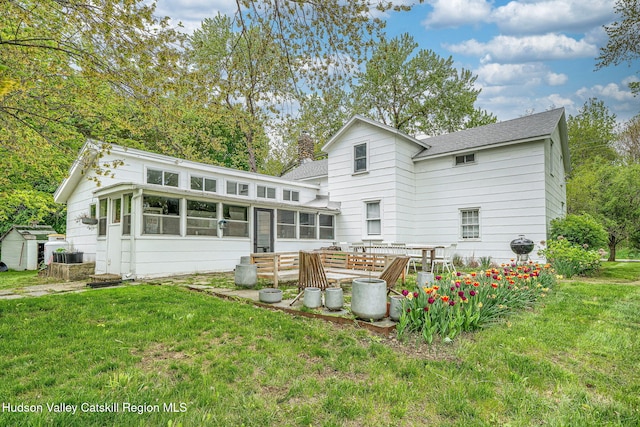 84 Old Rte 82, Hudson, NY 12534 - back of property featuring a sunroom, a yard, a chimney, a shingled roof, and a storage shed