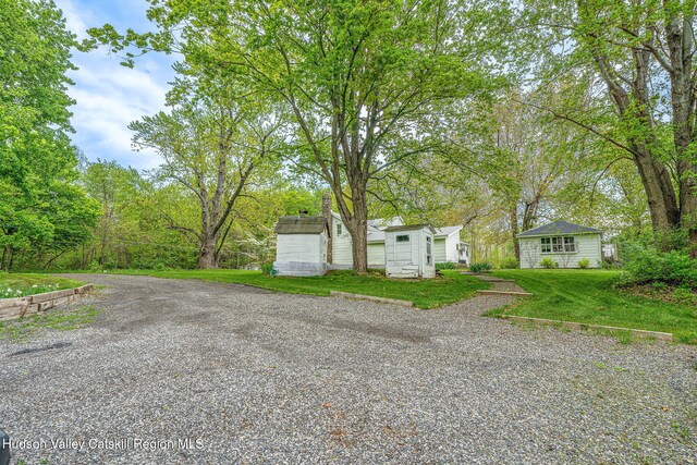 84 Old Rte 82, Hudson, NY 12534 - view of front of house with an outdoor structure, a shed, a front yard, and gravel driveway
