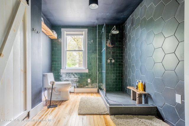 84 Old Rte 82, Hudson, NY 12534 - bathroom with hardwood / wood-style flooring, toilet, a shower stall, tile walls, and baseboard heating