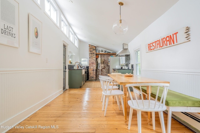 84 Old Rte 82, Hudson, NY 12534 - dining room featuring wainscoting, light wood-type flooring, baseboard heating, and vaulted ceiling