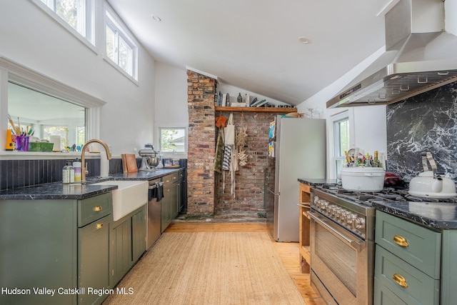 84 Old Rte 82, Hudson, NY 12534 - kitchen with green cabinetry, wall chimney exhaust hood, appliances with stainless steel finishes, light wood-style floors, and lofted ceiling