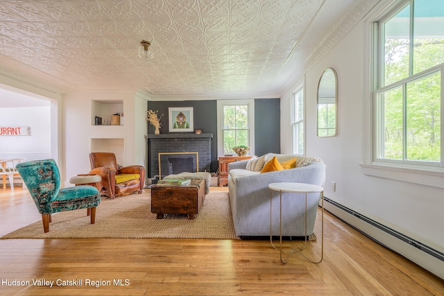 84 Old Rte 82, Hudson, NY 12534 - living room featuring a baseboard radiator, an ornate ceiling, a fireplace, and wood finished floors