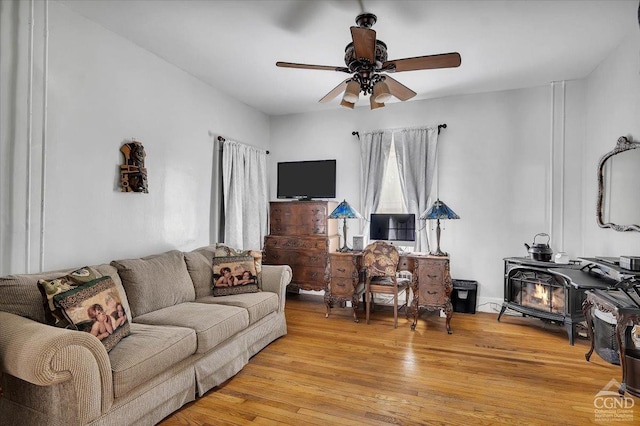 4916 Rte 81, Greenville, NY 12083 - living room featuring ceiling fan, light wood-style floors, and a wood stove