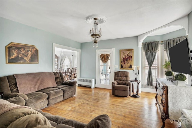 4916 Rte 81, Greenville, NY 12083 - living room with radiator heating unit, light wood-type flooring, and a chandelier