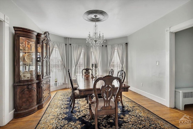 4916 Rte 81, Greenville, NY 12083 - dining area featuring a chandelier, wood finished floors, baseboards, and radiator heating unit