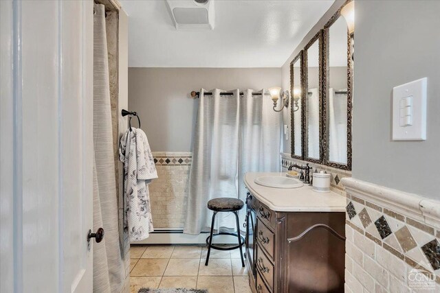 4916 Rte 81, Greenville, NY 12083 - full bathroom featuring baseboard heating, a wainscoted wall, vanity, and tile patterned floors