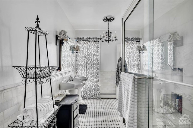 4916 Rte 81, Greenville, NY 12083 - full bathroom with tile walls, a baseboard radiator, a chandelier, a stall shower, and a wainscoted wall