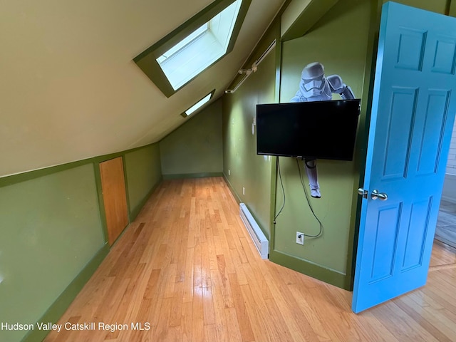 65 Bluebird Ln, Andes, NY 13731 - additional living space with a baseboard heating unit, a skylight, light wood finished floors, lofted ceiling, and baseboards