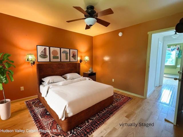 65 Bluebird Ln, Andes, NY 13731 - bedroom with wood finished floors, baseboards, a ceiling fan, and baseboard heating
